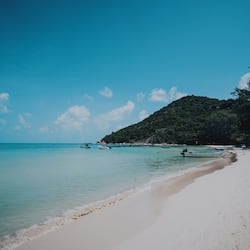 On the beach, white sand, beach umbrellas, beach towels