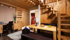 A modern kitchen with wooden cabinetry, a dining table, and a built-in bench.