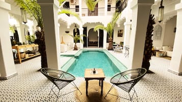 Piscine extérieure, parasols de plage, chaises longues