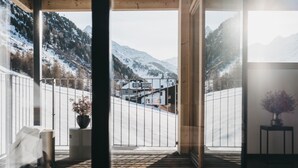 A wooden deck with a view of a snowy mountain landscape. - The Crystal VAYA Unique (Obergurgl)