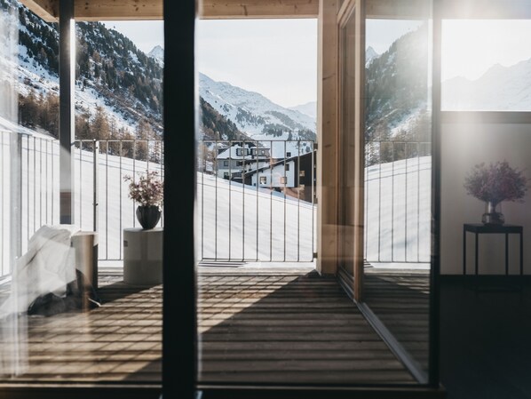 A wooden deck with a view of a snowy mountain landscape. - The Crystal VAYA Unique (Obergurgl)