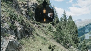 A table set for dining with a view of a mountainous landscape through a window. - The Crystal VAYA Unique (Obergurgl)