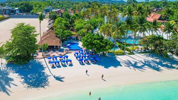 On the beach, white sand, sun loungers, beach umbrellas
