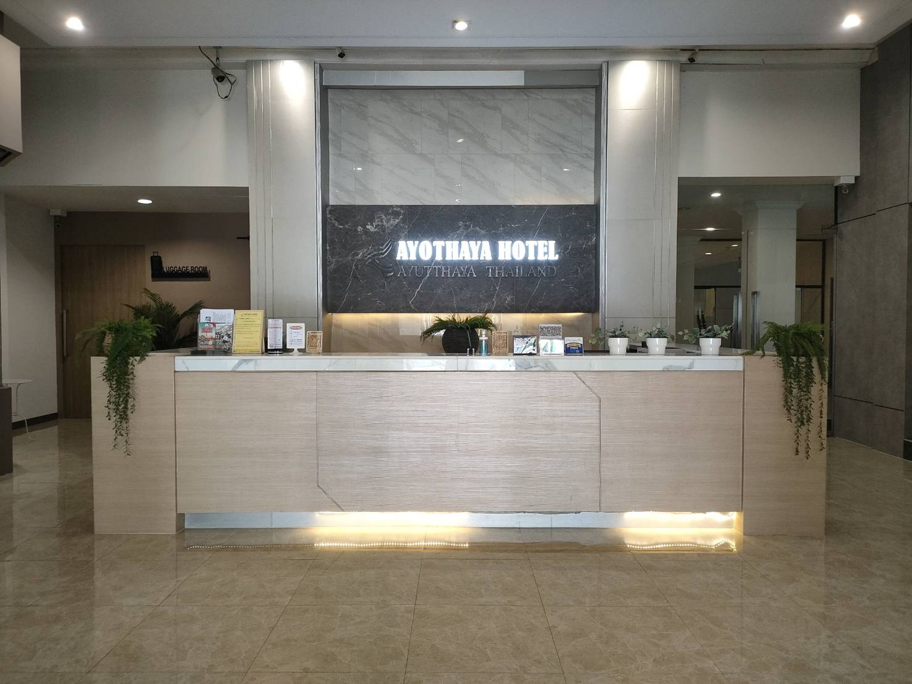 A reception desk with a sign reading 'AYOTHAYA HOTEL' and 'AYUTHAYA THAILAND'.
