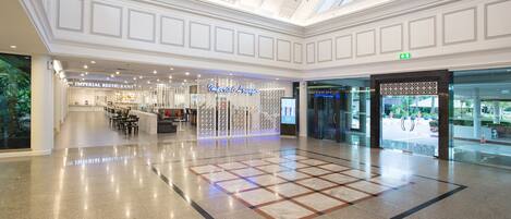 A spacious atrium with a high ceiling, a chandelier, and a central seating area.