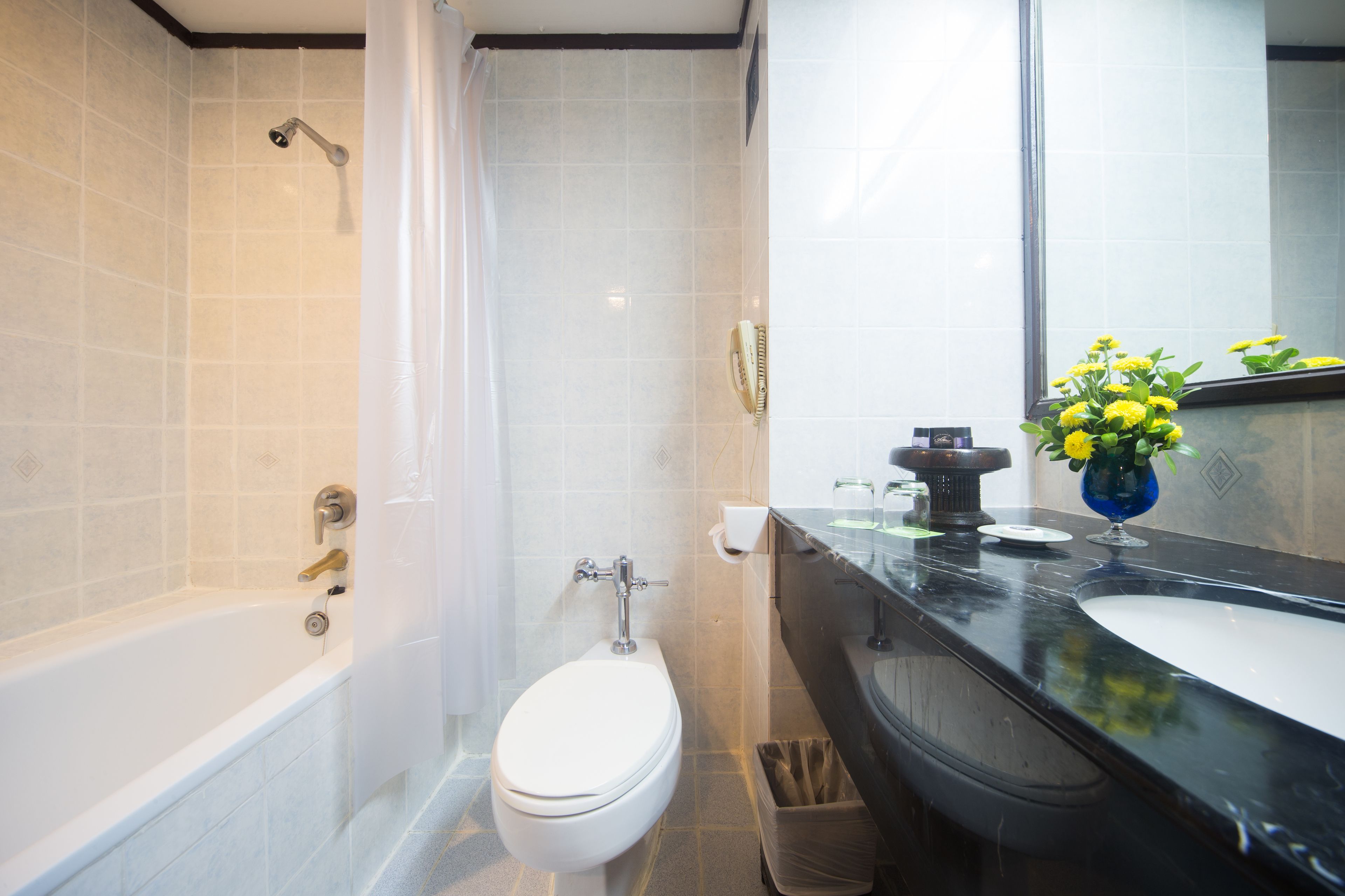 A modern bathroom with a bathtub, toilet, and sink.