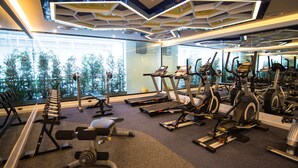 A gym with treadmills, elliptical machines, and weight benches. - The Beach Boutique House (Karon)
