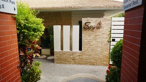 A building entrance with a sign reading "Spa" and a directional sign pointing to "Beach Park." - The Beach Boutique House (Karon)