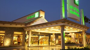 A hotel entrance with a covered walkway and a sign indicating the name and type of hotel. - Holiday Inn Al Khobar - Corniche by IHG (Al Khobar)