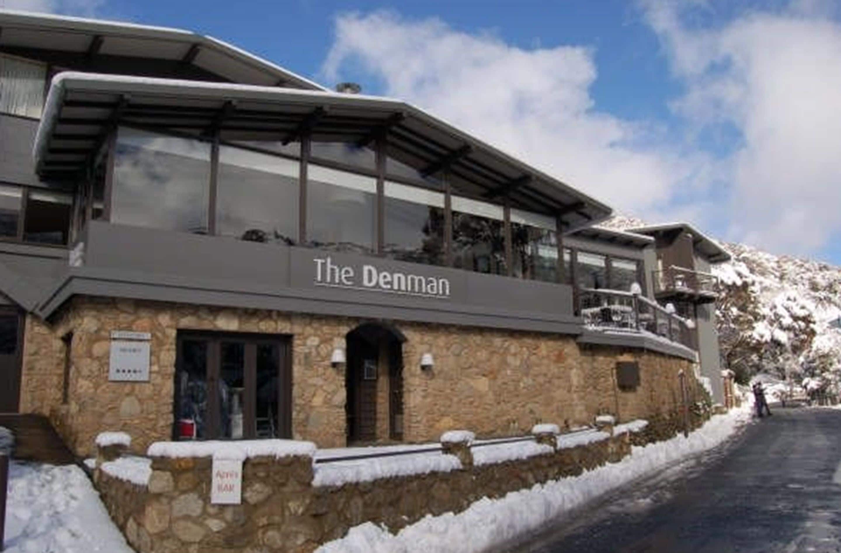 A stone building with a sign reading "The Denman."