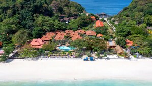 An aerial view of a resort with multiple buildings, a swimming pool, and a beach. - P. P. Erawan Palms Resort (Ko Phi Phi)