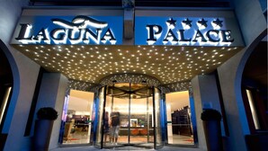 The entrance of Laguna Palace with a revolving door and illuminated signage. - Laguna Palace Hotel (Grado)