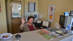A reception desk with a computer, a telephone, and various brochures. - Residence Edy (Imperia)