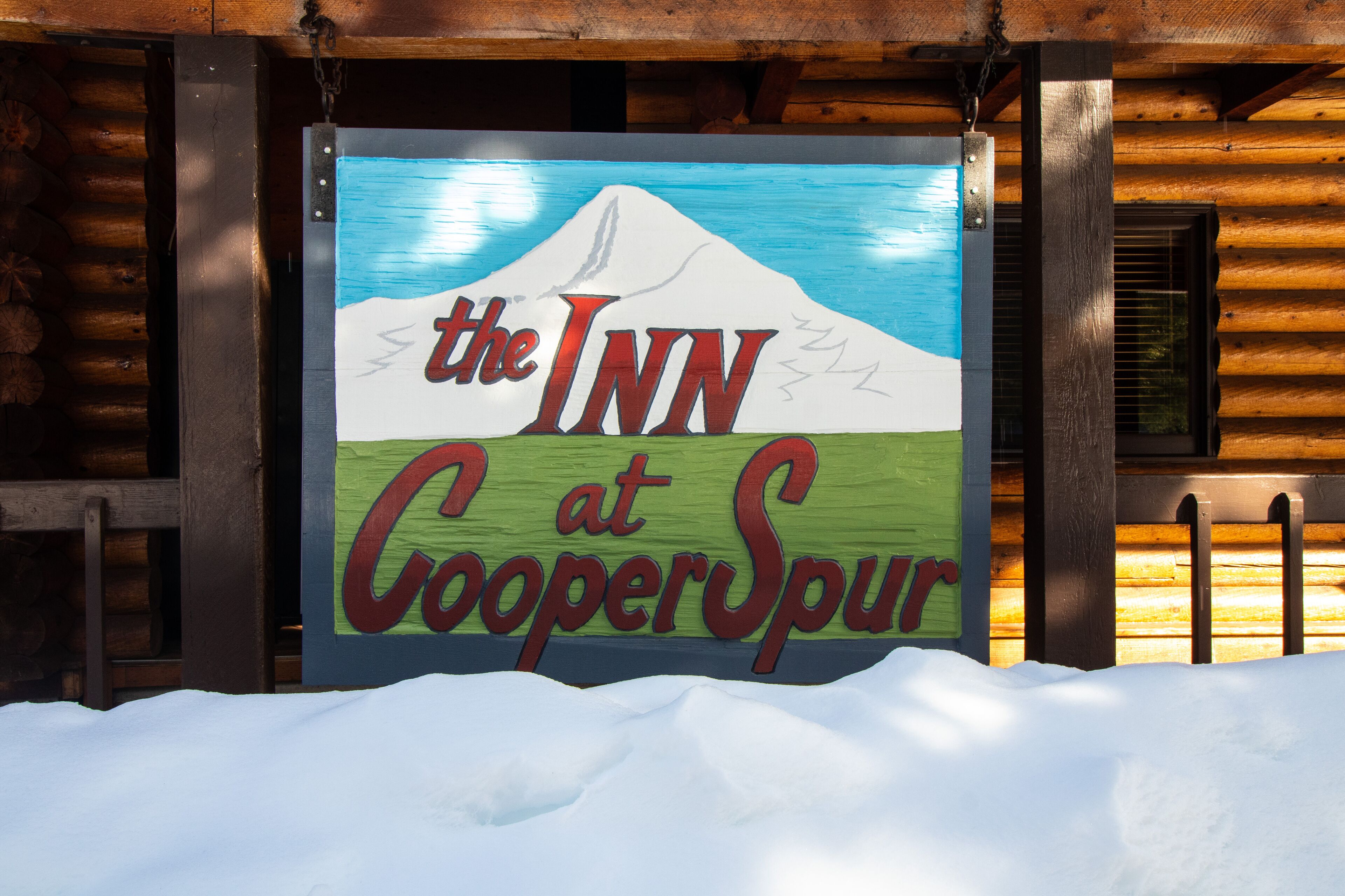 A sign for "The Inn at Cooper Spur" with a mountain illustration.