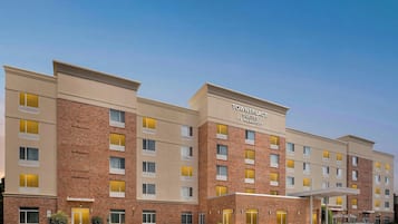 Un edificio de hotel de varios pisos con un letrero que dice 'TOWNPLACE SUITES BY MARRIOTT'.
