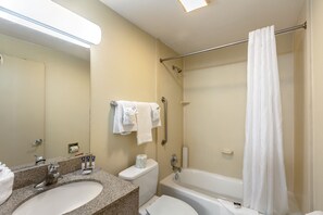 A bathroom with a sink, toilet, and bathtub.