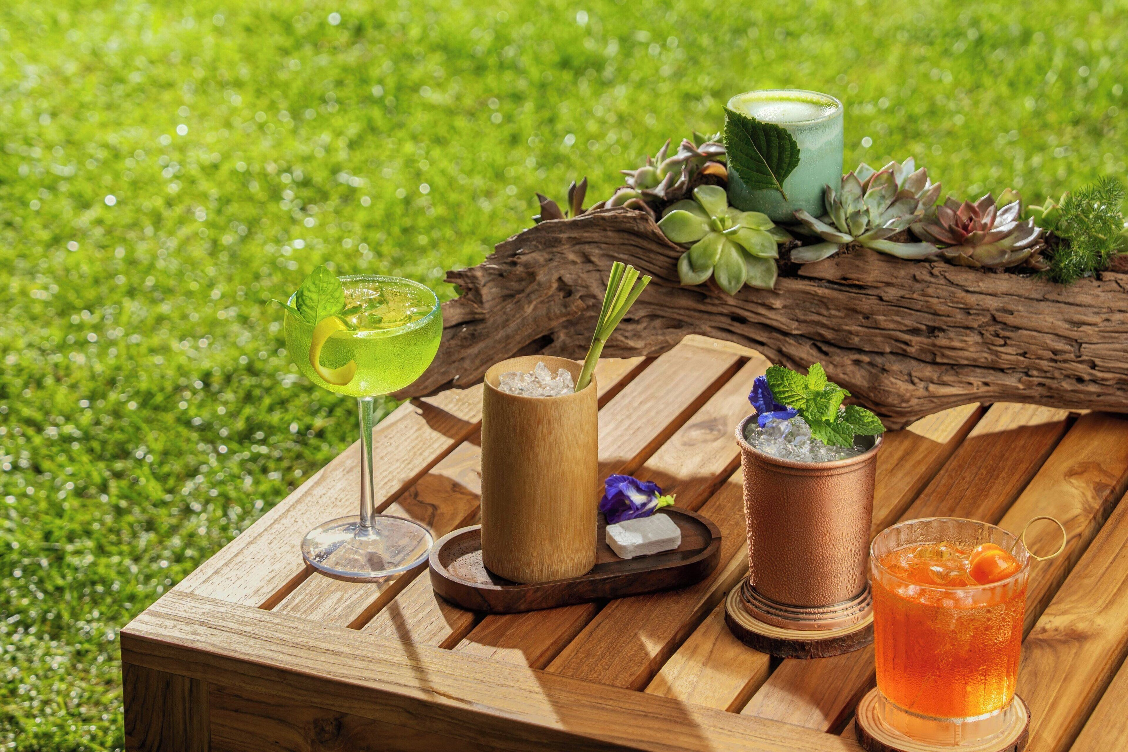 A wooden table with drinks and a rustic setting.