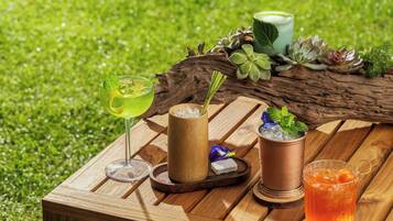 A wooden table with drinks and a rustic setting.