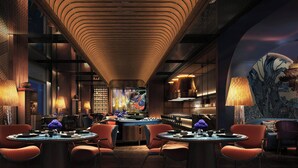 A restaurant with a modern interior, featuring a long counter, round tables, and orange upholstered chairs. - JW Marriott Hotel & Suites Saigon (Ho Chi Minh City)
