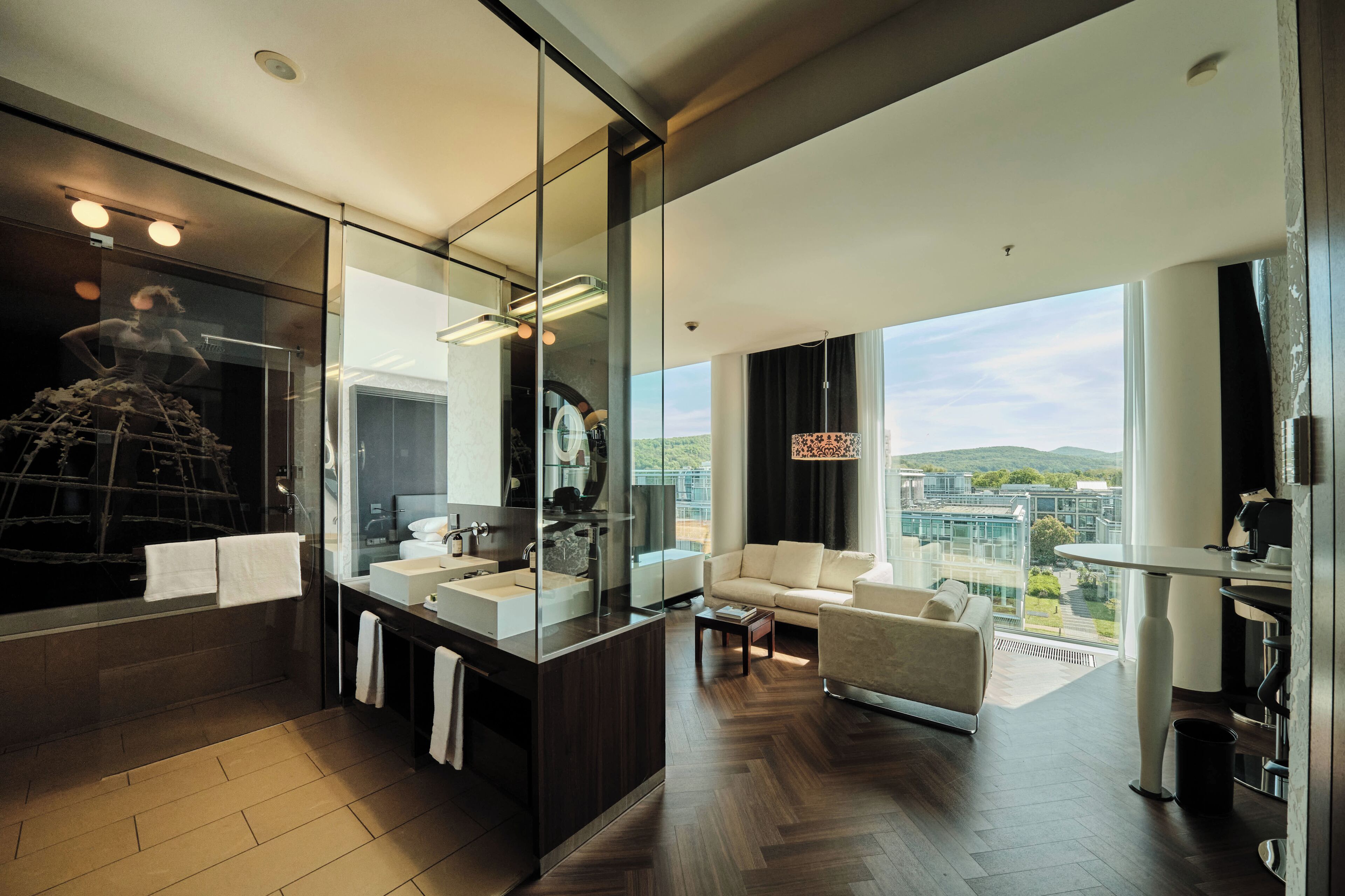 A modern bathroom with a large mirror, a vanity, and a shower area.
