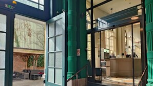A hotel entrance with a staircase leading to a reception area. - Best Western Urban Hotel  (Lille)