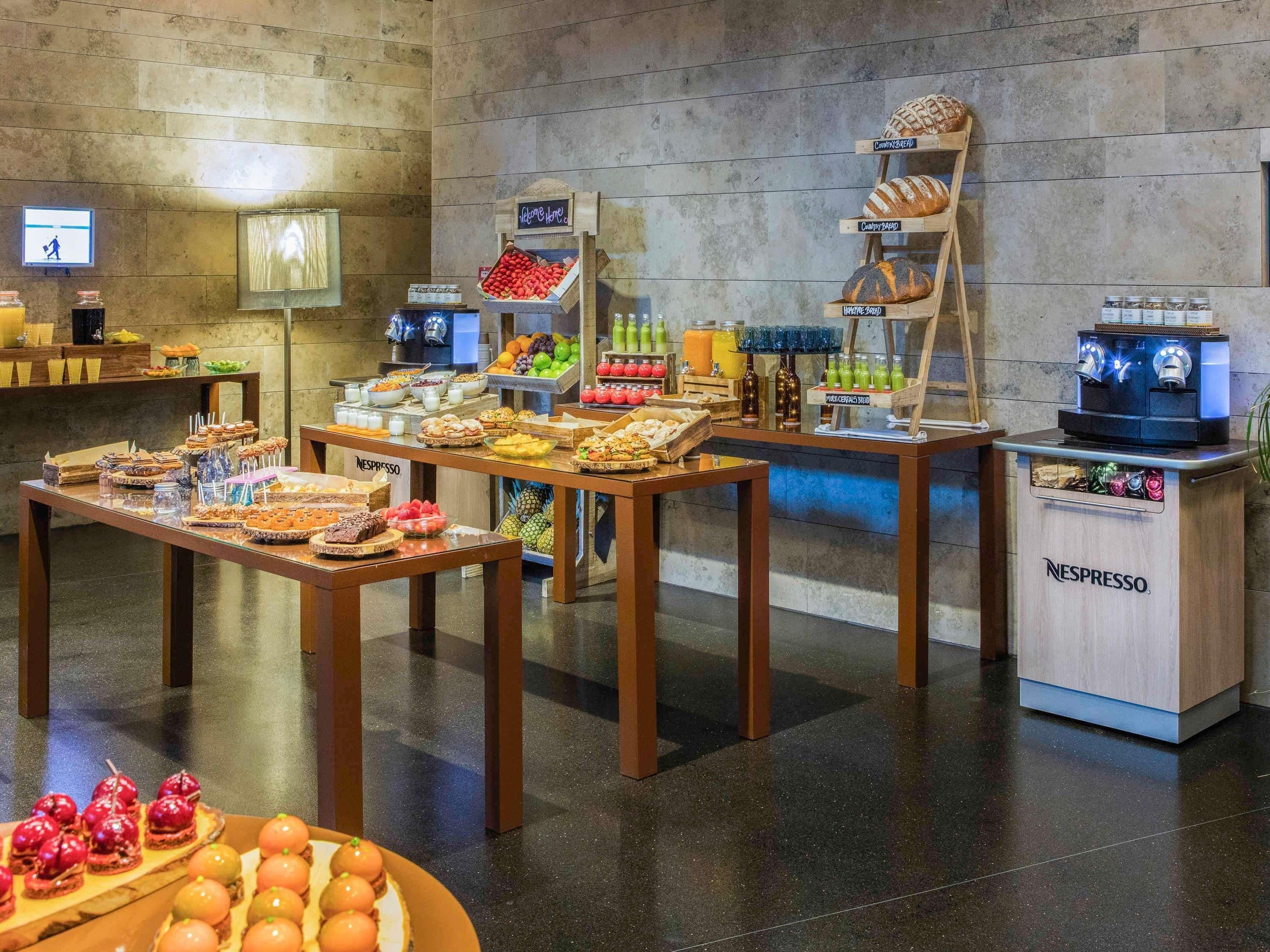 A breakfast buffet with various food items and a coffee station.