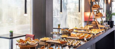 A buffet with various food items and a bread display.