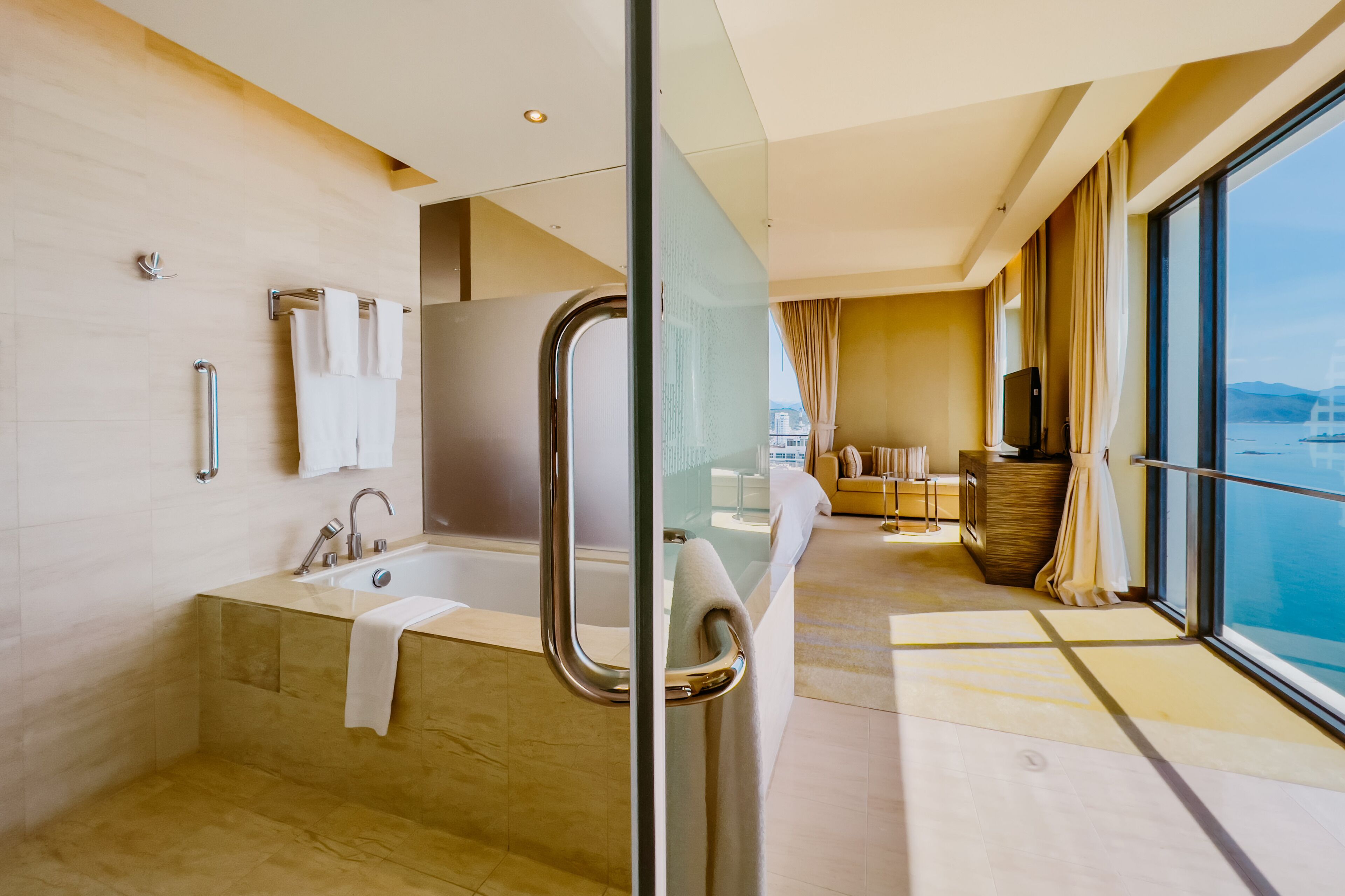 A modern bathroom with a bathtub, a glass shower enclosure, and a vanity with a mirror.