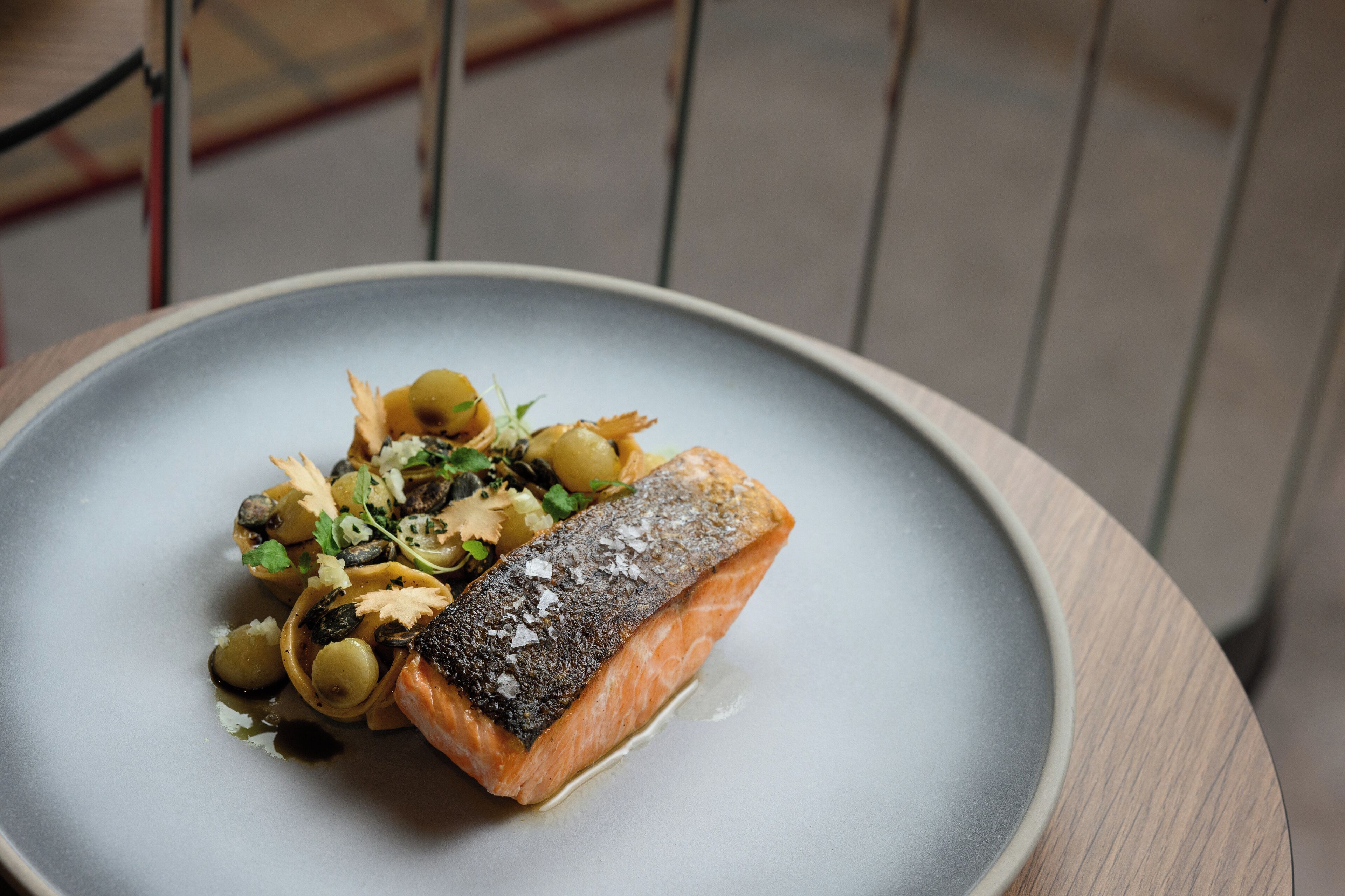 A plate of food with a piece of salmon and vegetables.