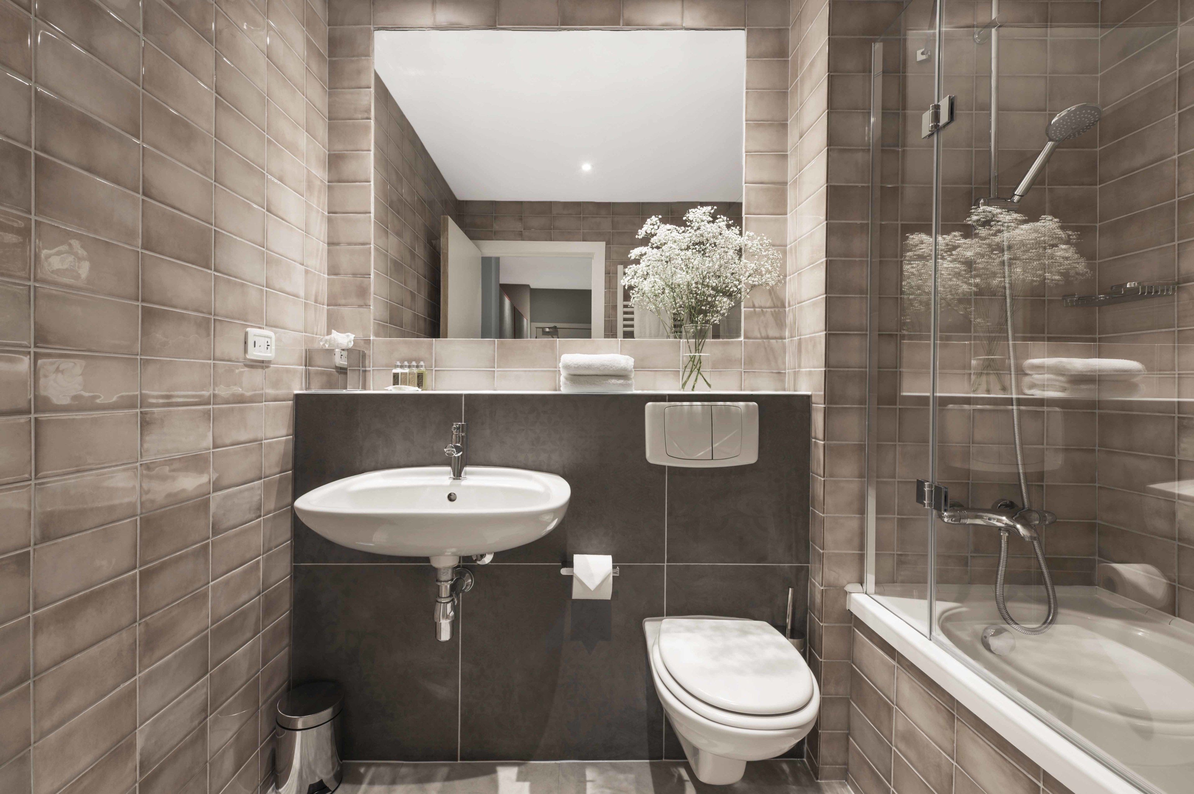 Executive One Bedroom Suite | Bathroom | Designer toiletries, hair dryer, towels, soap