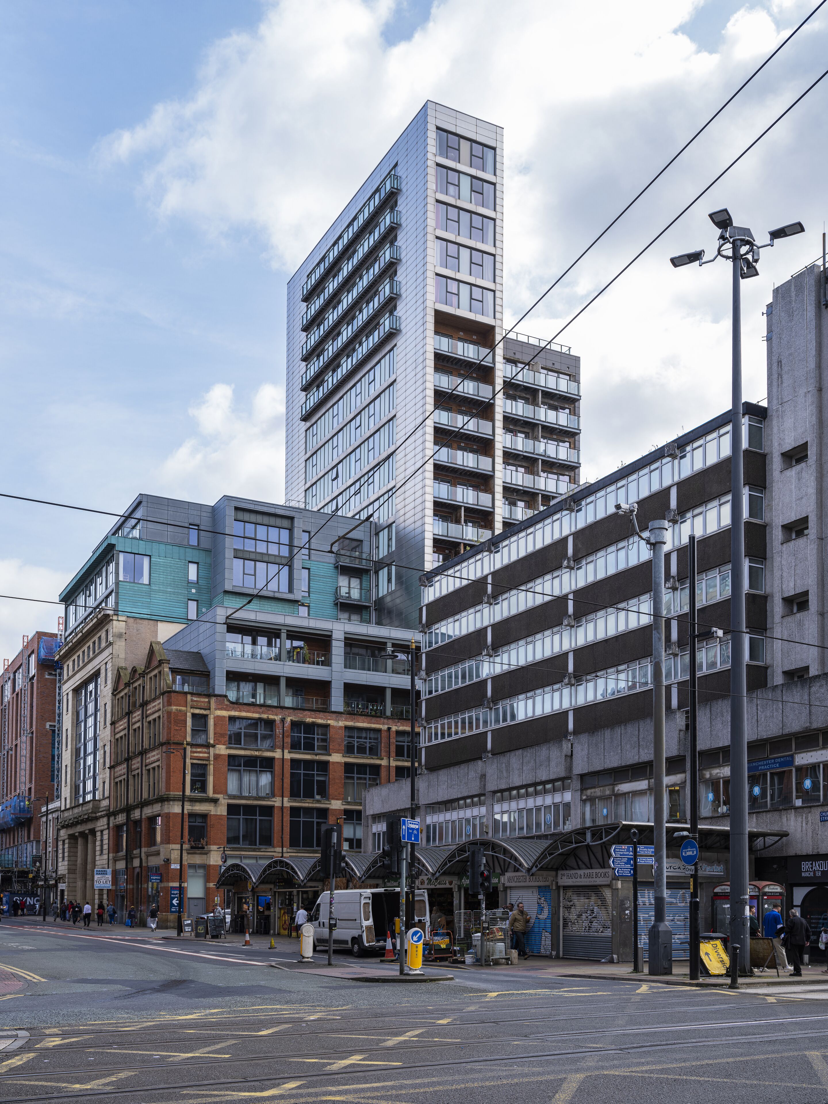 A multi-story building with a modern architectural design, featuring a mix of glass and brick facades.