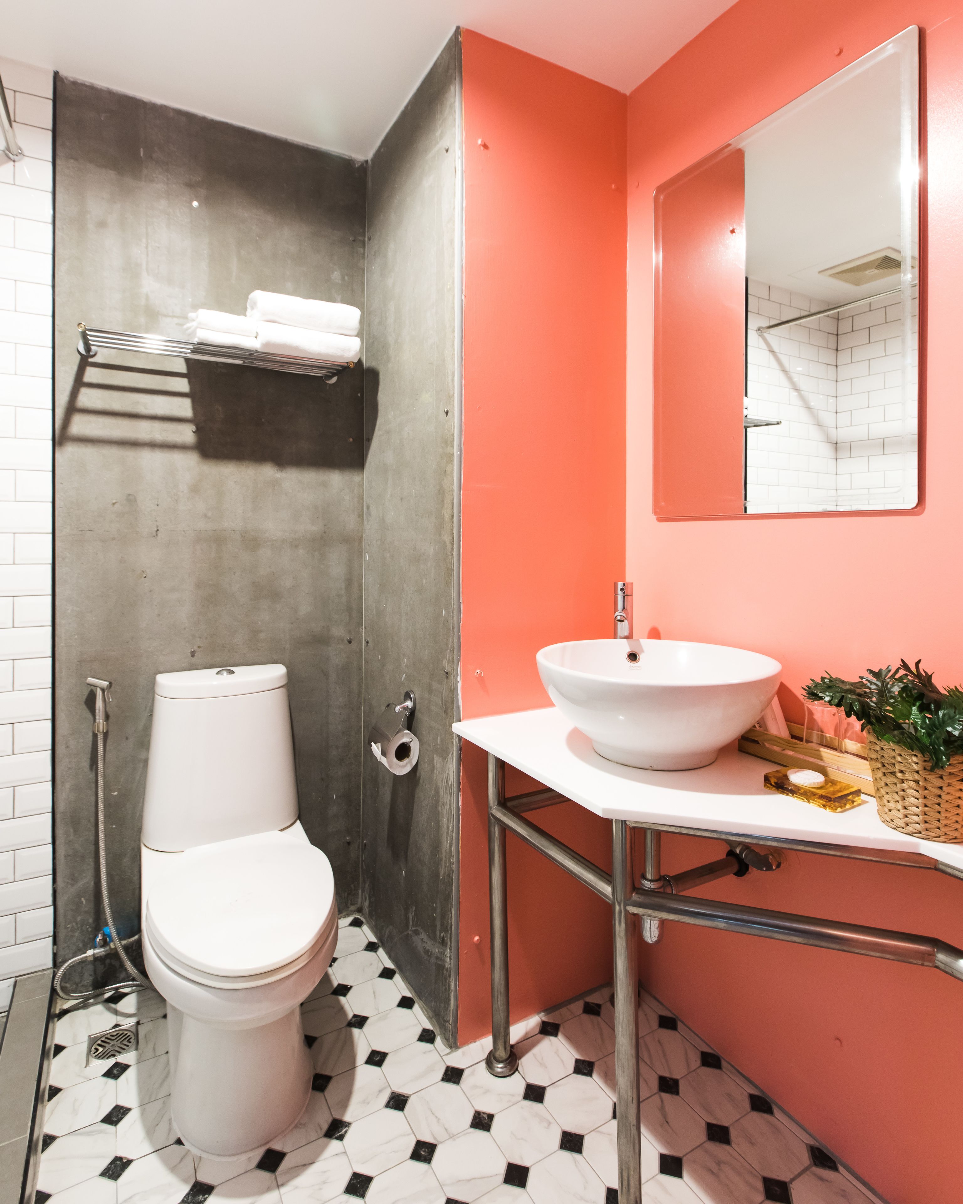 A bathroom with a white toilet, a white sink, and a mirror.