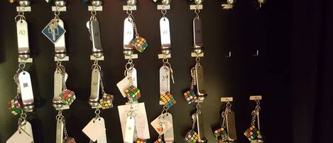 A wall of numbered metal tags with attached colorful objects.