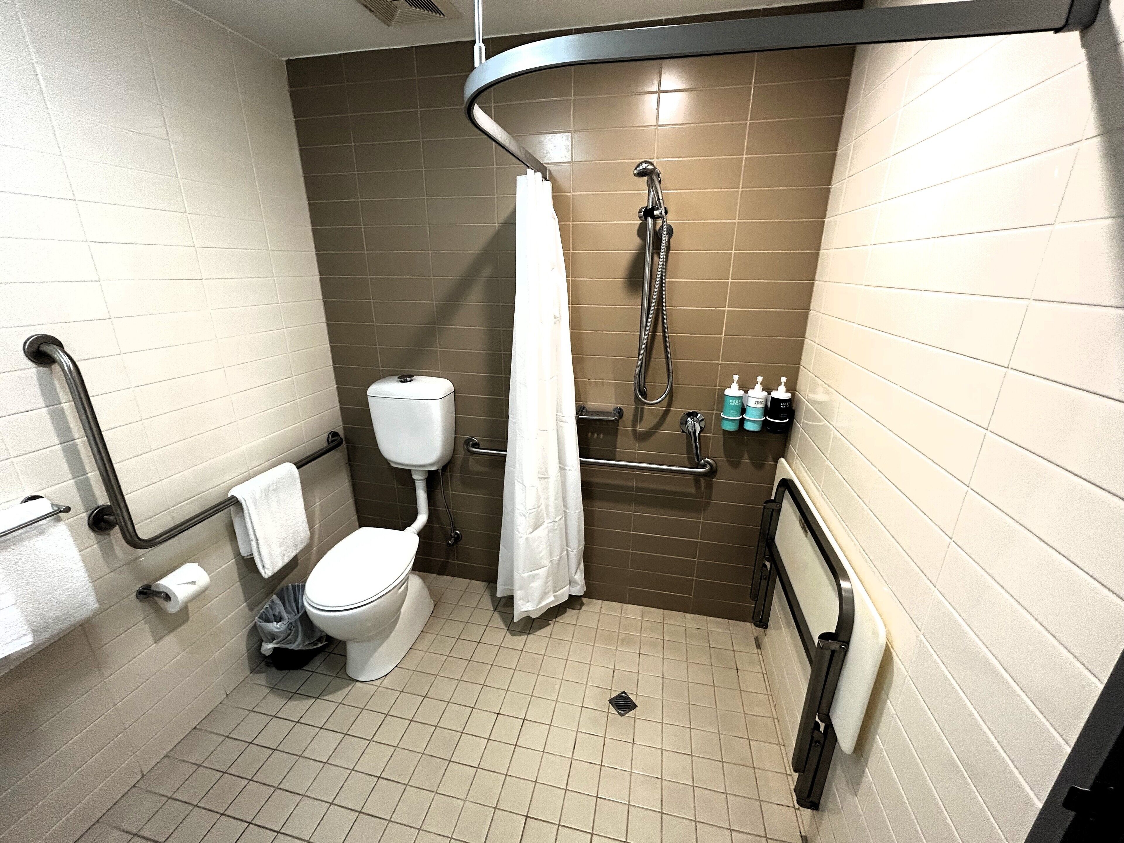 rainfall showerhead, eco-friendly toiletries, hair dryer, towels