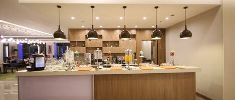 A modern kitchen with wooden cabinets, a central island, and pendant lighting.