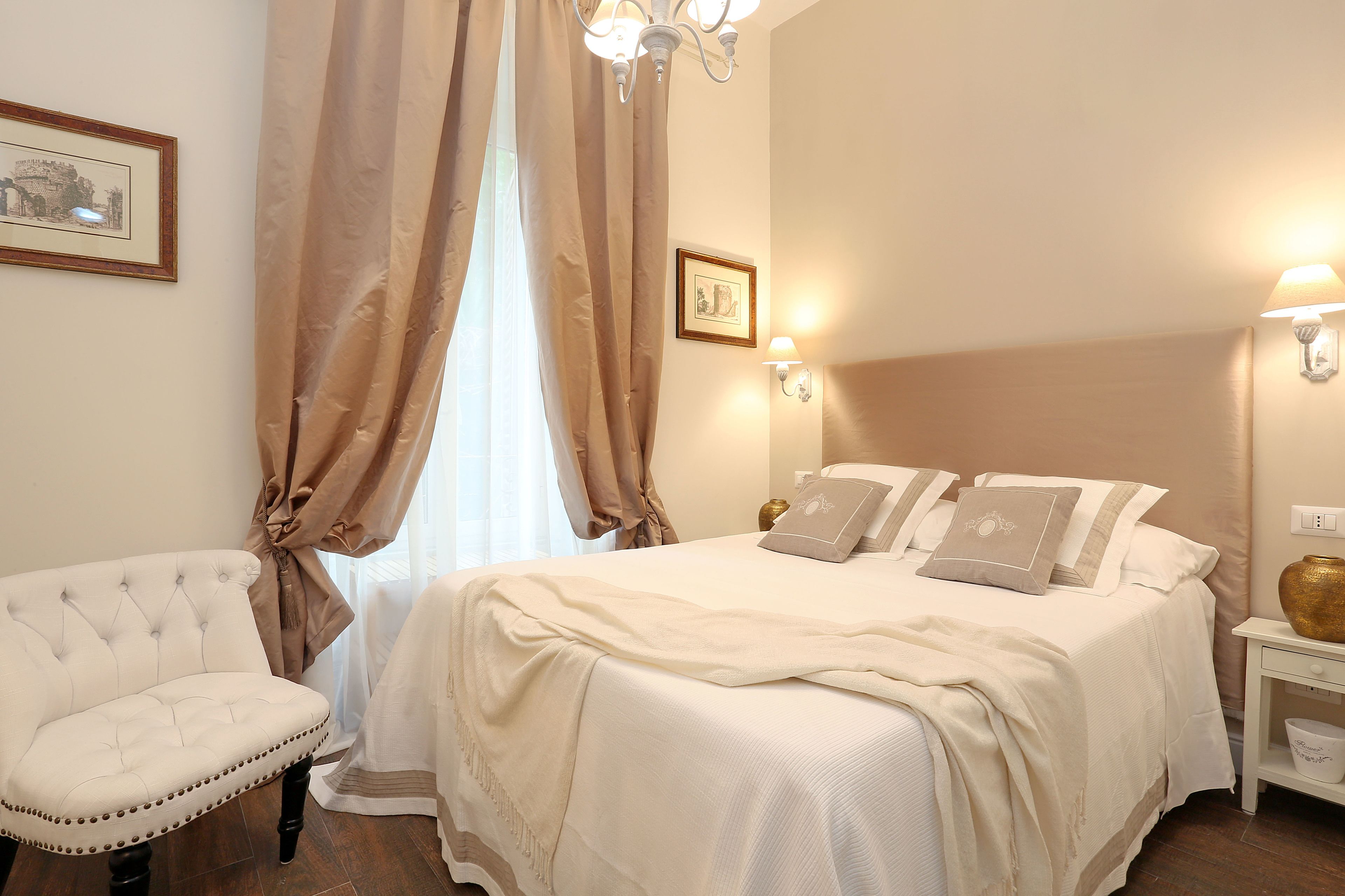 A neatly arranged bedroom with a bed, a chair, and a nightstand.