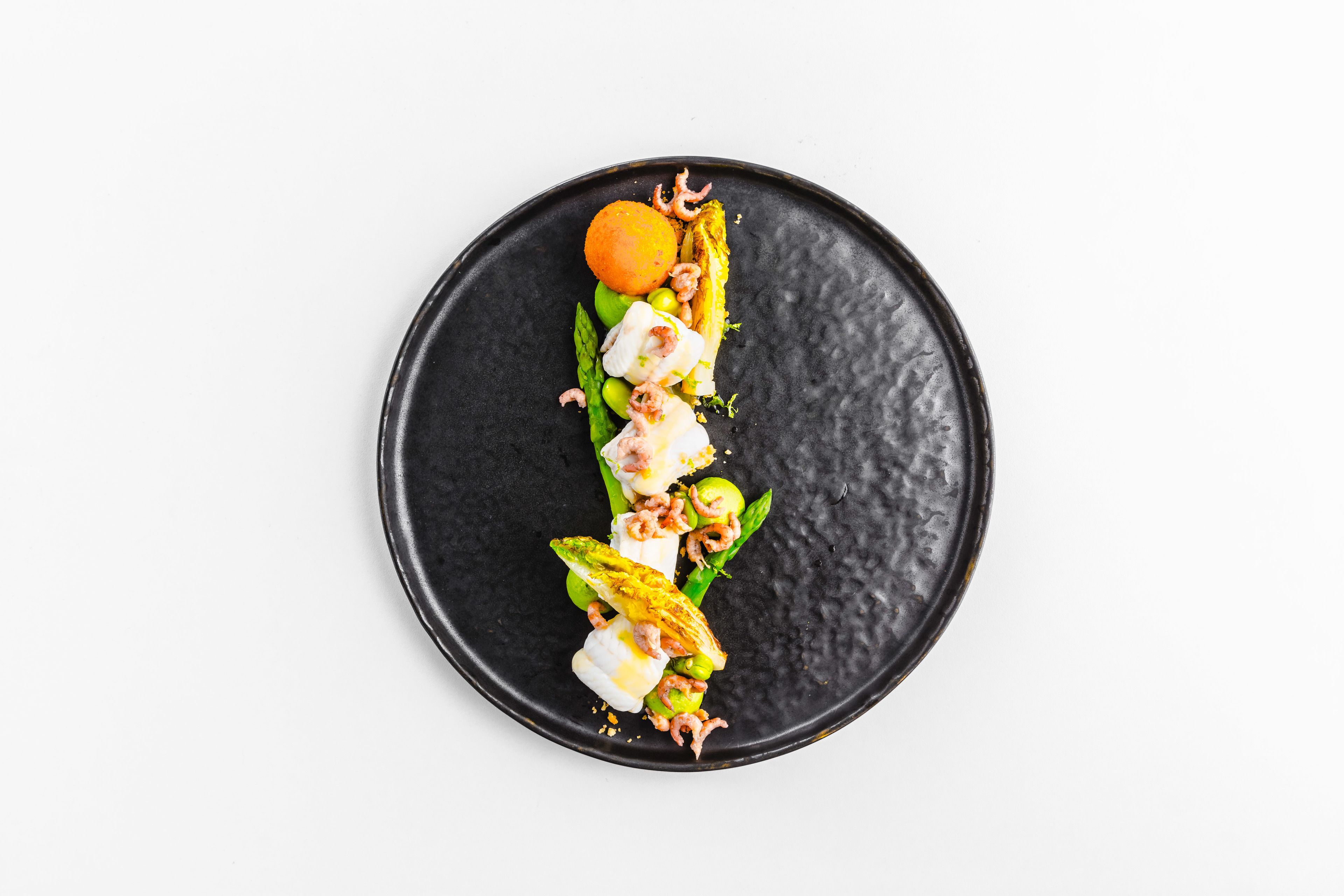 A black plate with a food arrangement.