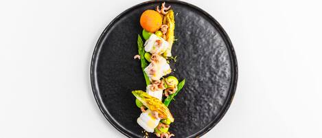 A black plate with a food arrangement.