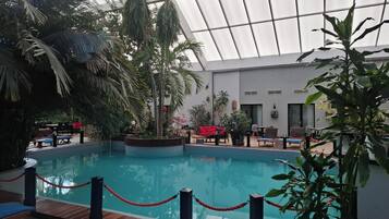 Indoor pool, open 10:00 AM to 7:00 PM, pool loungers