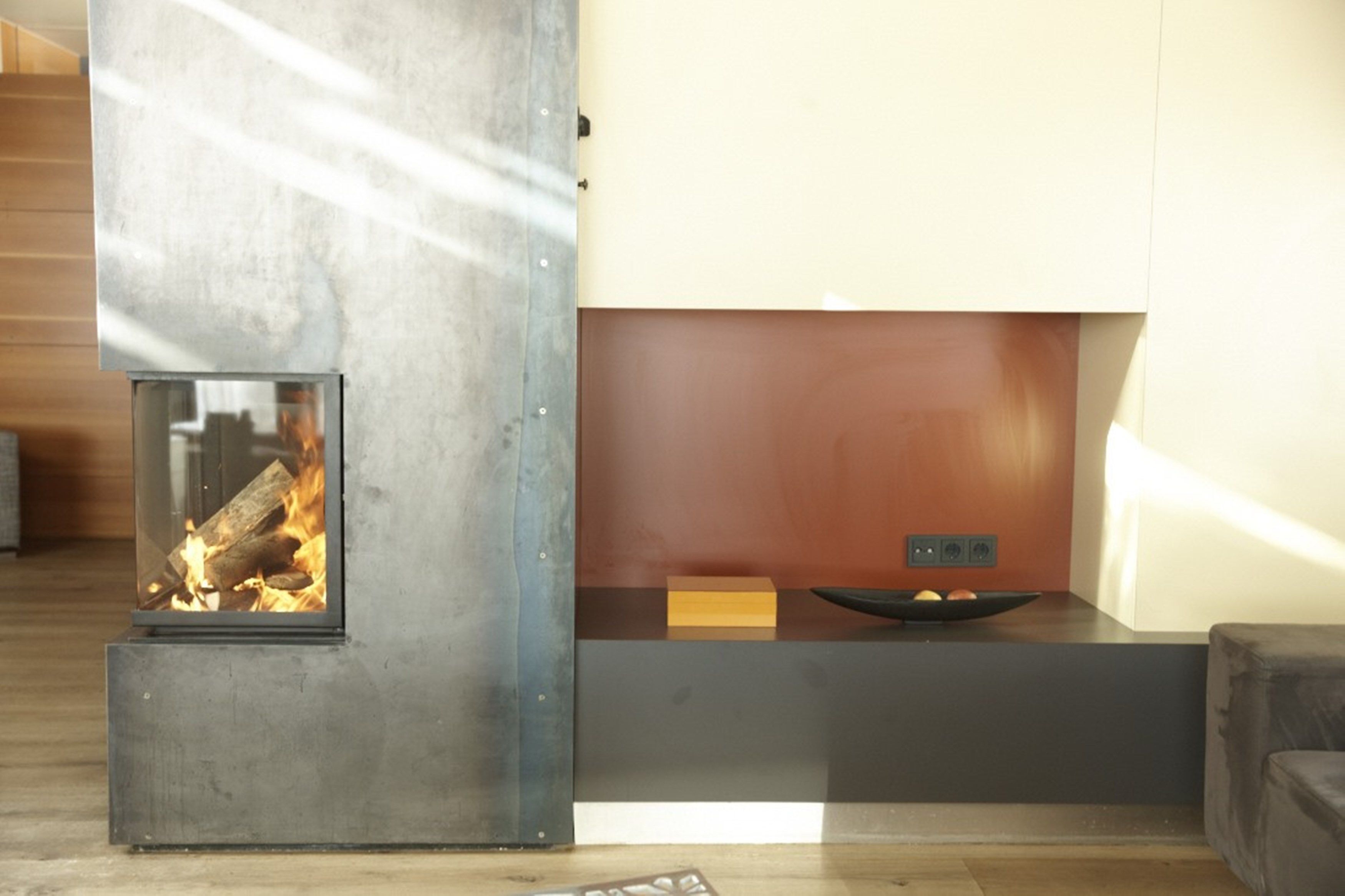 Una sala de estar moderna con chimenea integrada, piso de madera y diseño minimalista.