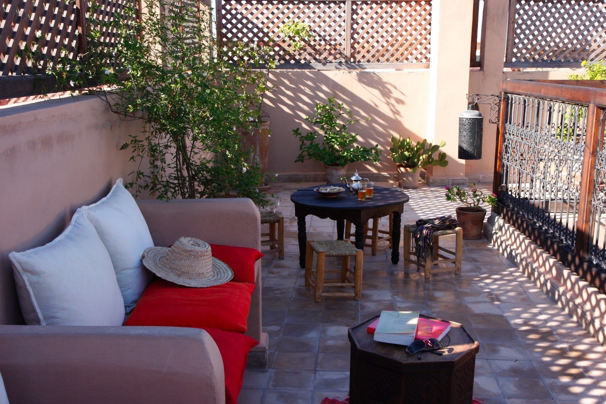 A cozy outdoor seating area with a sofa, chairs, and a table.