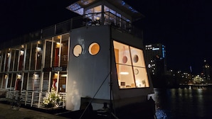 A floating hotel with a balcony, large windows, and a sign reading "HOTEL". - CPH Living (Copenhagen)