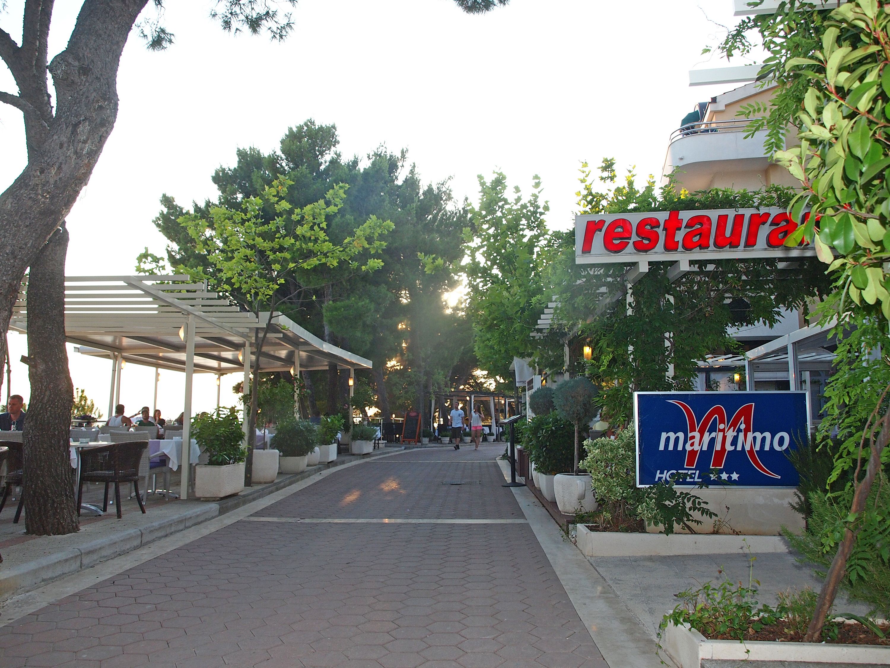 A restaurant with outdoor seating and a covered area.