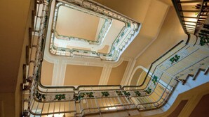 A grand, ornate staircase with intricate metal railings and a central open area. - Grand Hotel Regina (Salsomaggiore Terme)