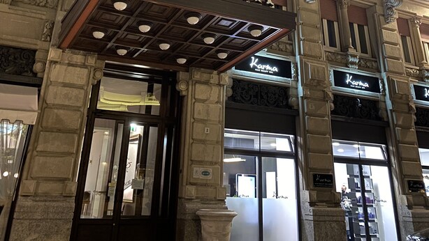 The exterior of the Albergo Regina hotel with ornate architectural details, a prominent entrance, and flags. - Grand Hotel Regina (Salsomaggiore Terme)