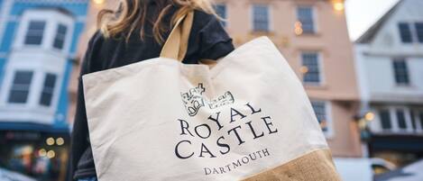 A person carrying a Royal Castle DARTMOUTH tote bag.