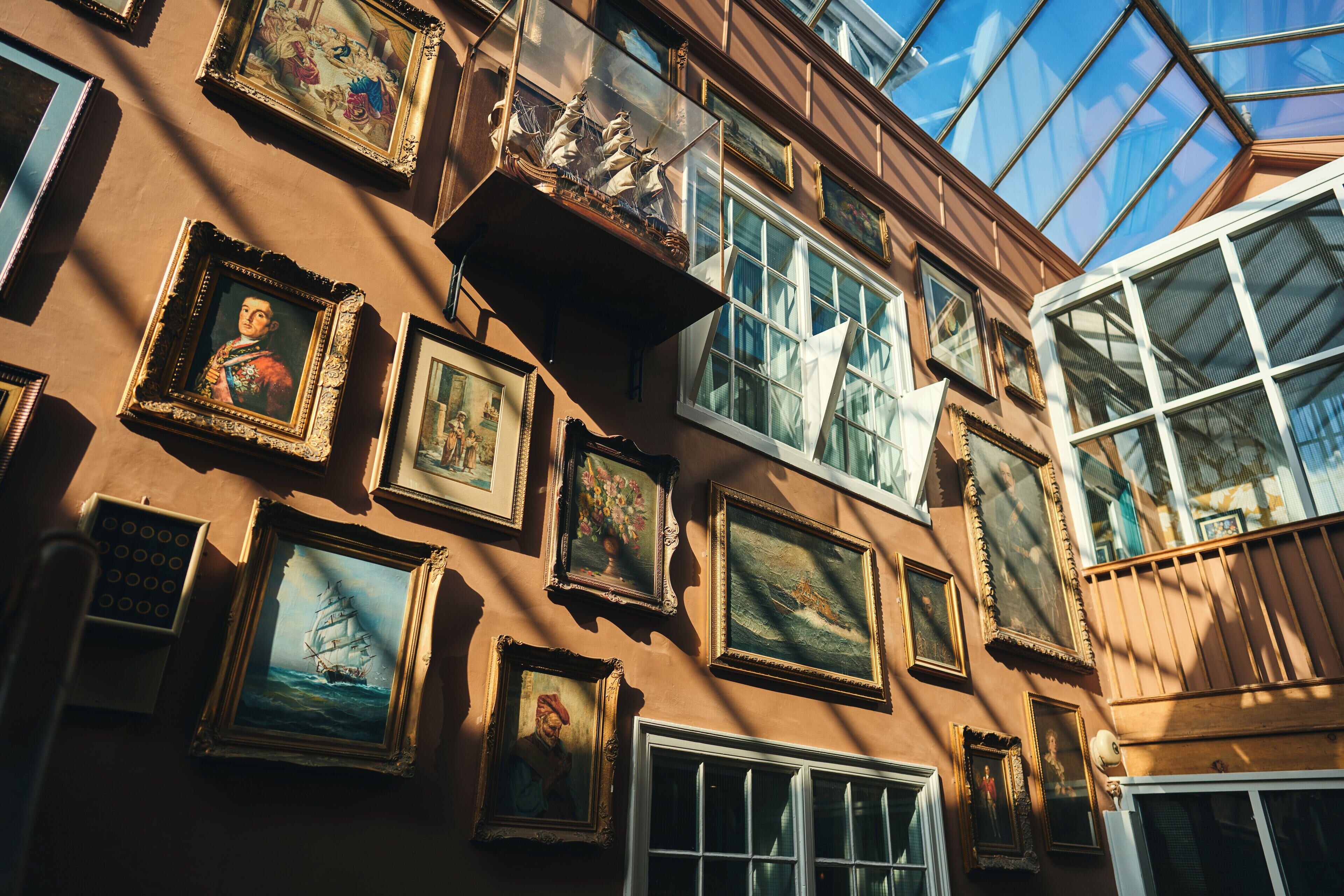 A building facade with multiple windows and framed artworks.