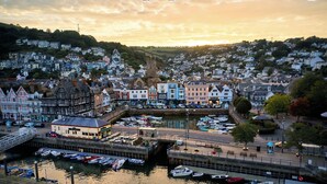 A coastal town with a marina, historic buildings, and a church. - Royal Castle Hotel (Dartmouth)