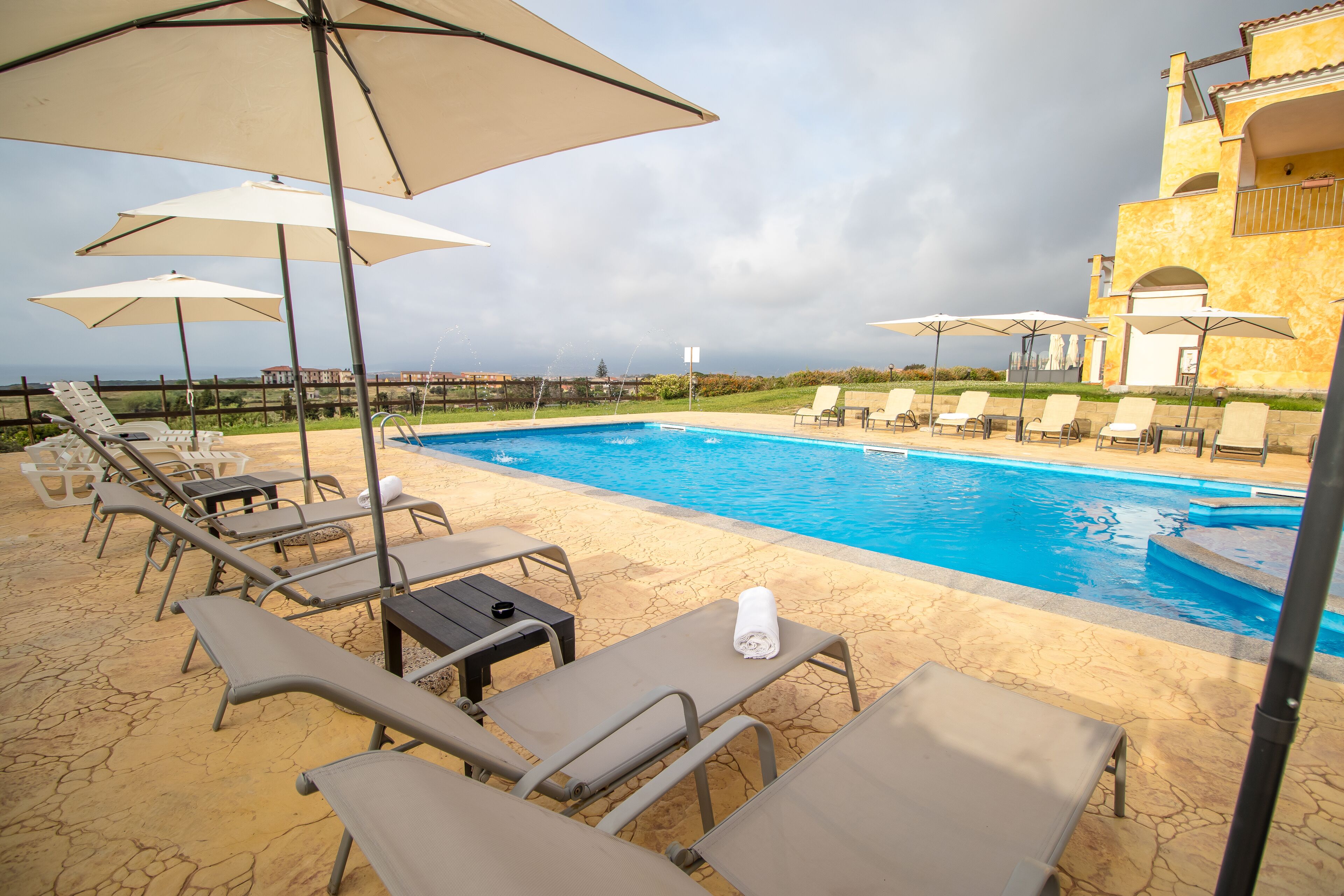 outdoor pool, pool umbrellas, pool loungers