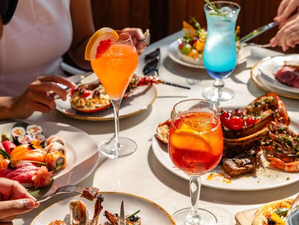A dining table with various dishes and drinks. - Fairmont Bab Al Bahr (Abu Dhabi)
